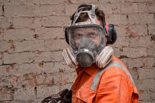 worker inhaling toxic dust